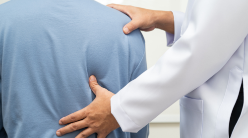 Doctor examining a patient’s neck and spine to assess nerve impingement symptoms