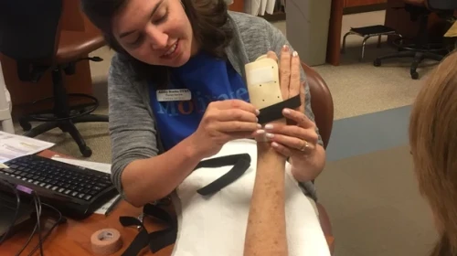 Therapist Helping from OrthoCarolina
