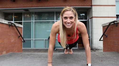 Strengthen your Core with OrthoCarolina | Woman Smiling and Doing a Plank