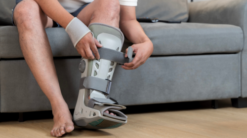 Person putting on leg boot during their Laser-Guided Bone Healing