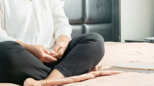 Older Woman Doing Yoga and Meditating Indoors