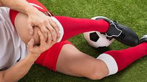 Soccer Player Grabbing Her Knee After Injury