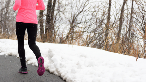 woman running in the cold winter snow