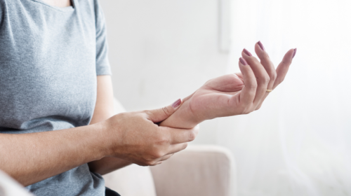 Woman experiencing hand numbness