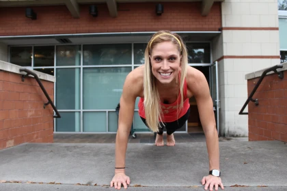 Strengthen your Core with OrthoCarolina | Woman Smiling and Doing a Plank