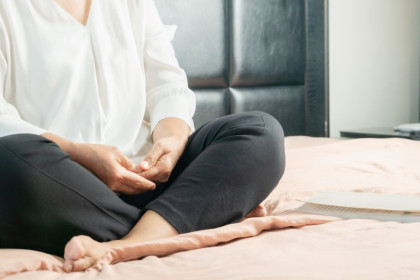 Older Woman Doing Yoga and Meditating Indoors