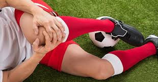 Soccer Player Grabbing Her Knee After Injury