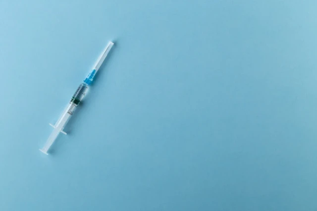 Regenerative Medicine | Stock Photo of Medical Needle on Blue Background
