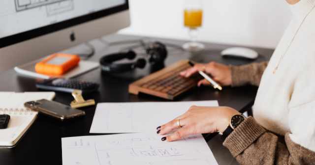 Office worker typing on a computer with focus on wrist positioning to prevent injury