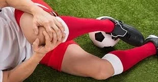 Soccer Player Grabbing Her Knee After Injury