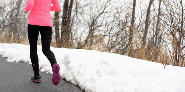 woman running in the cold winter snow