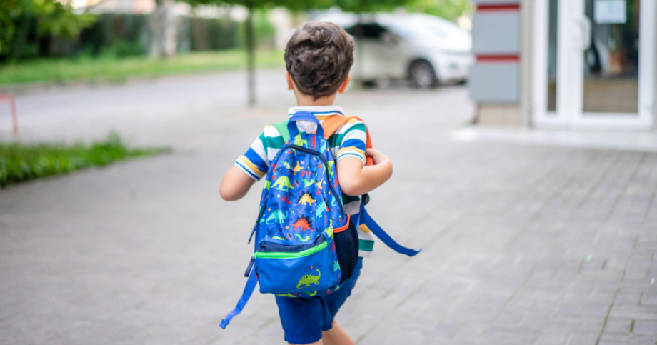 Child running with backpack.