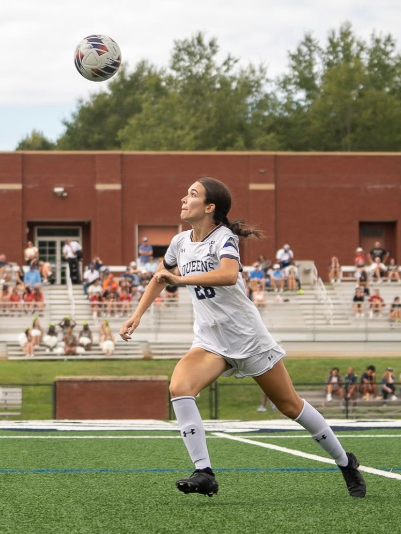 Female Athlete Running on Soccer Field