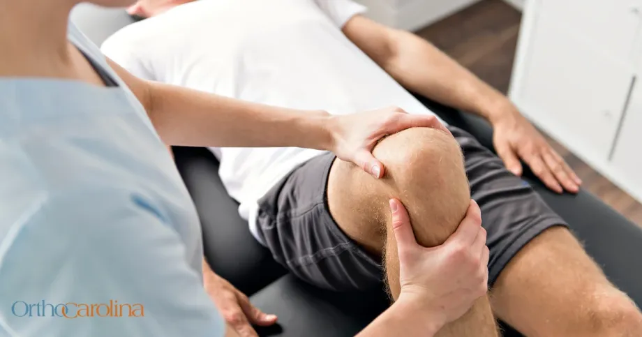 orthopedic specialist with patient evaluating knee joint