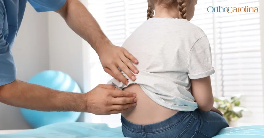 orthopedic specialist looking at childs spine