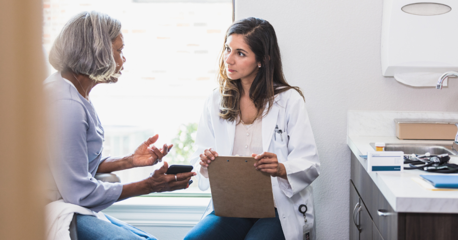 Patient discussing pain symptoms with orthopedic doctor