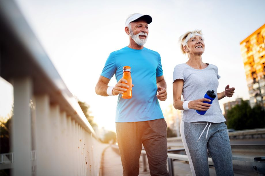 middle aged couple jogging together middle aged couple jogging together