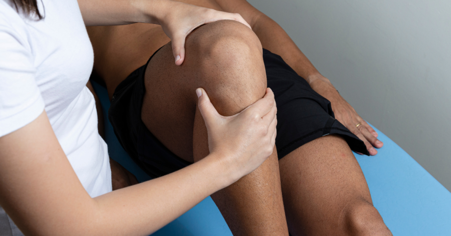 Orthopedic specialist inspecting patients knee.